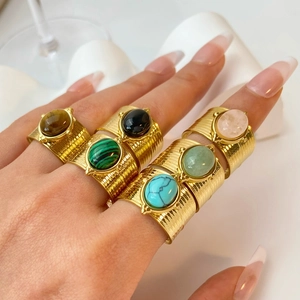 Set of 6 gold plated wide band rings with natural gemstones on a hand, french retro style