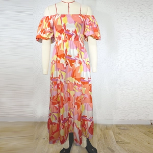Detail view of colorful abstract print on summer off-shoulder long dress with puff sleeves
