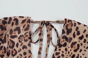 Detailed close-up of leopard print fabric with sexy lace-up halter tie neck design