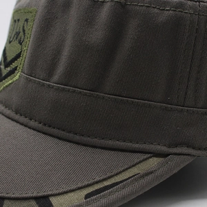 Detailed close-up of heavy olive canvas fabric and U.S. embroidery on cadet cap
