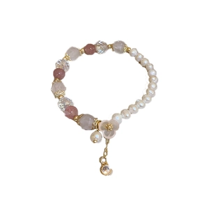 Aquamarine camellia beaded stretch bracelet with pink crystals and pearls on white background