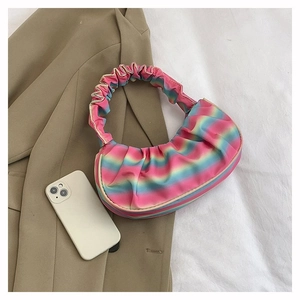Detail of the rainbow gradient pleated texture and elastic handle on the shoulder bag