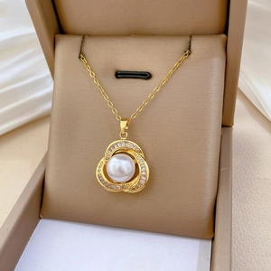 Detailed macro view of a gold pearl necklace with diamond accents in a luxury gift box