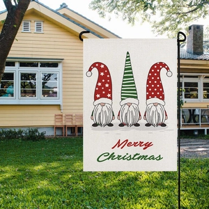 Detail of Christmas garden flag with gnomes and Merry Christmas print on burlap