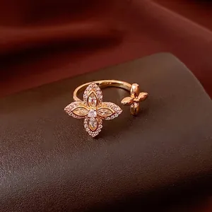 Luxurious gold flower open ring with micro-set zircons on a dark velvet display