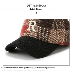 Detail showing the sturdy brim and white R embroidery on the plaid baseball cap