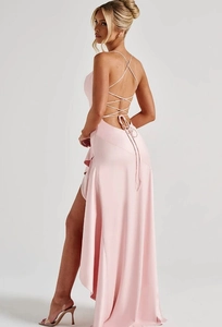 Detail view of the open back crisscross straps and high slit on a pink satin dress