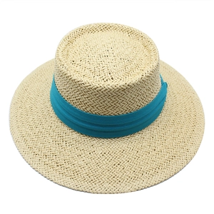Top view of a straw boater hat with a natural weave texture and a wide lake blue ribbon