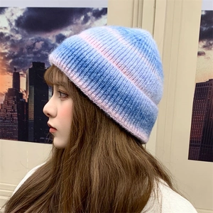 Detail view of pink and blue tie-dye gradient knit beanie with soft ribbed texture