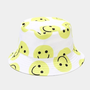 White canvas bucket hat with yellow smiley face patterns for sun protection and street style