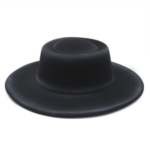 Top view of a black wool felt boater hat featuring a unique circular recessed crown design