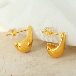 Elegant gold teardrop stud earrings with a polished finish on a minimalist stone base