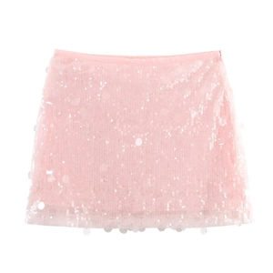 Detailed view of pale pink mini skirt featuring shimmering round sequin textures on fabric
