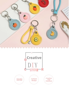 Close-up of fruit-themed PU leather keychains with 3D silicone orange and peach motifs