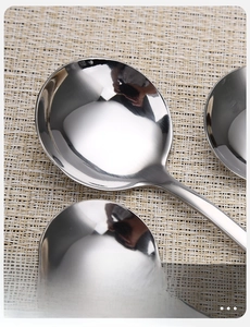 Close-up of polished stainless steel spoon with smooth rounded edges and mirror finish