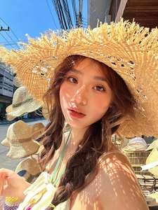 Detail of wide brim raffia sun hat with frayed edges for summer beach vacation
