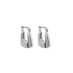 Detailed close-up of chunky U-shaped metal earrings with a mirror-polished silver finish