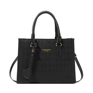 Minimalist black quilted leather tote bag with gold logo and heart charm detail