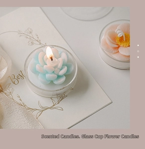Close-up of blue flower scented candle in glass cup with elegant gift card decoration