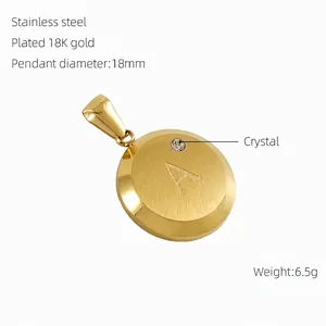 Detail of 18K gold plated 18mm round pendant with brushed texture and crystal 'A' letter