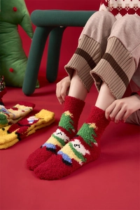 Detail of warm coral fleece Christmas socks featuring festive tree and snowman embroidery