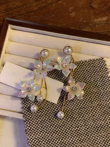 Detailed macro of flower earrings with long tassels, pearls and crystal accents
