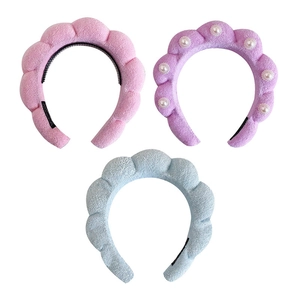 Three colorful braided cloud headbands in pink, blue, and purple with pearl details
