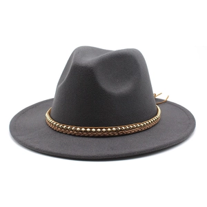 Detail of dark grey wool fedora hat featuring a brown woven leather band and gold bead chain