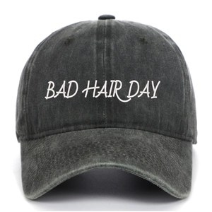 Détail de la broderie blanche BAD HAIR DAY sur une casquette en coton gris délavé