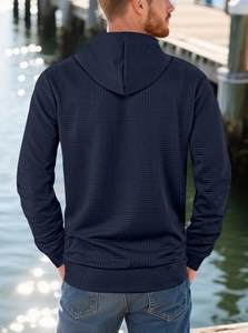 Outdoor shot of men's navy blue hoodie with high-quality embossed texture and relaxed fit