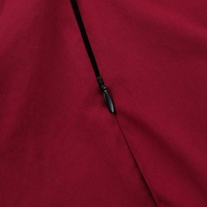 Detail of invisible black zipper closure on a wine red sleeveless square neck dress