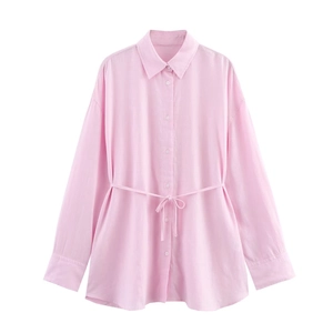 Close-up of pink cotton shirt detailing lapel collar and waist drawstring tie