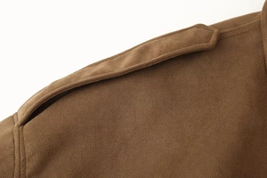 Detail of brown faux suede bomber jacket showing shoulder strap and fine stitching