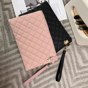 Pink and black quilted faux leather clutch handbags with gold metal clasps and wrist straps