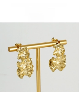 Detail showing irregular molten texture and zircons on gold-plated titanium earrings