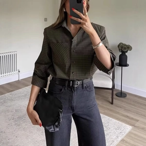 Modern plaid shirt with lapel collar and chest pocket in deep green and brown tones