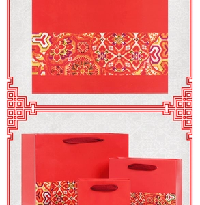 Three sizes of red festive paper gift bags with traditional gold and red patterns
