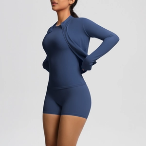 Detail view of navy blue zip-up sports jacket and slim-fit yoga shorts set for women