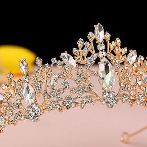 Close-up of golden bridal tiara with floral rhinestone patterns and intricate filigree