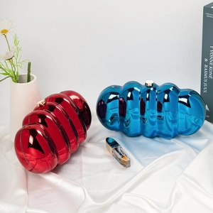 Cloud-shaped acrylic clutch bags with metallic mirror finish in bright red and electric blue