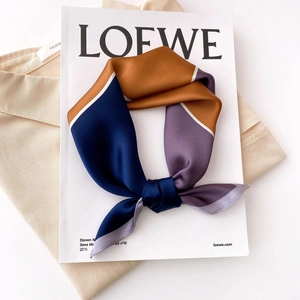 Striped silk square scarf with geometric blocks in caramel and blue, elegant bow styling