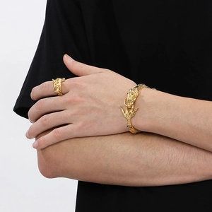 Detailed view of golden Chinese dragon head ring and bracelet set on male model