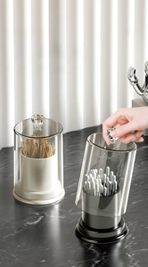 Detail of transparent storage jars with crystal knobs and black and white bases