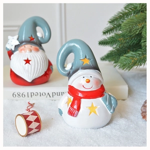 Close-up of hollow star cut-outs on Santa and snowman Christmas table ornaments