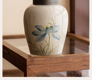 Macro view of hand-painted lotus pattern and gray-blue glaze on the ceramic tea canister