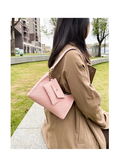 Detailed view of pink woven texture shoulder bag with mini coin purse on outdoor model