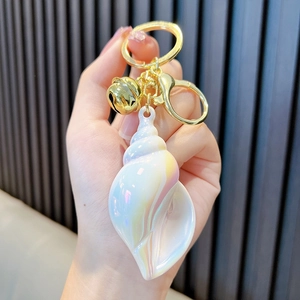 Colorful iridescent conch seashell keychain with golden bell and metal clip accessory