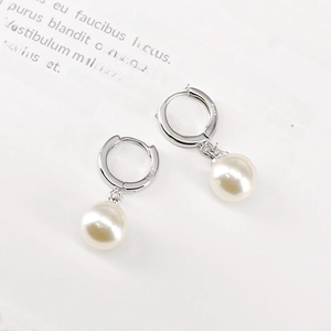Detailed macro shot of S925 sterling silver stamp on long elegant pearl drop earrings