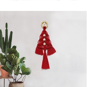 Detailed view of handmade red woven Christmas tree tapestry with wooden beads and tassels