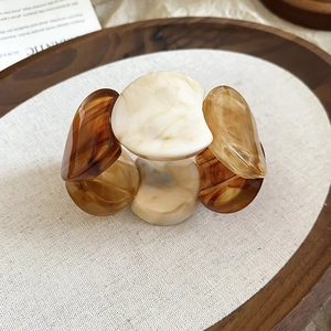 Detailed macro view of marbled acrylic resin links on a vintage chunky stretch bracelet